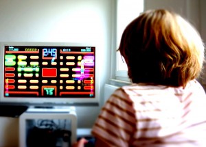 http://commons.wikimedia.org/wiki/File:Girl_plays_Pac_Man.JPG