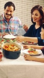 http://commons.wikimedia.org/wiki/File:Family_eating_meal.jpg
